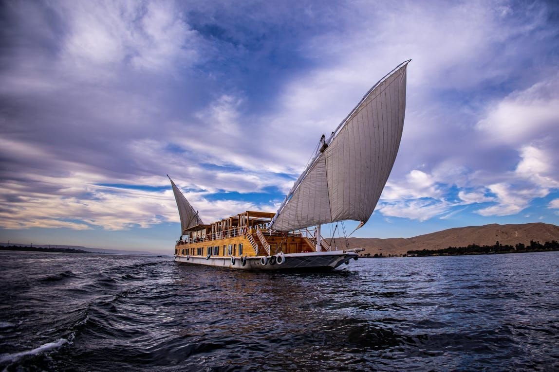 Traditional two-masted Dahabiya sailing on the Nile